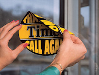 2-sided static cling being applied on store window.
